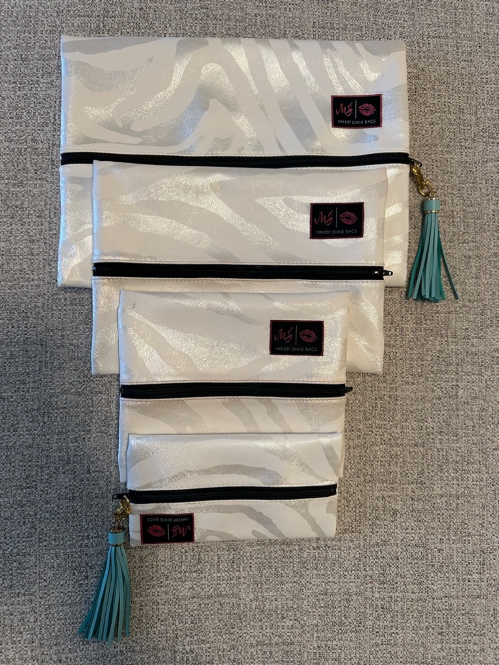 Makeup Junkie Set of 4 White Shimmer Zebra Print Pouches with Teal Tassels
